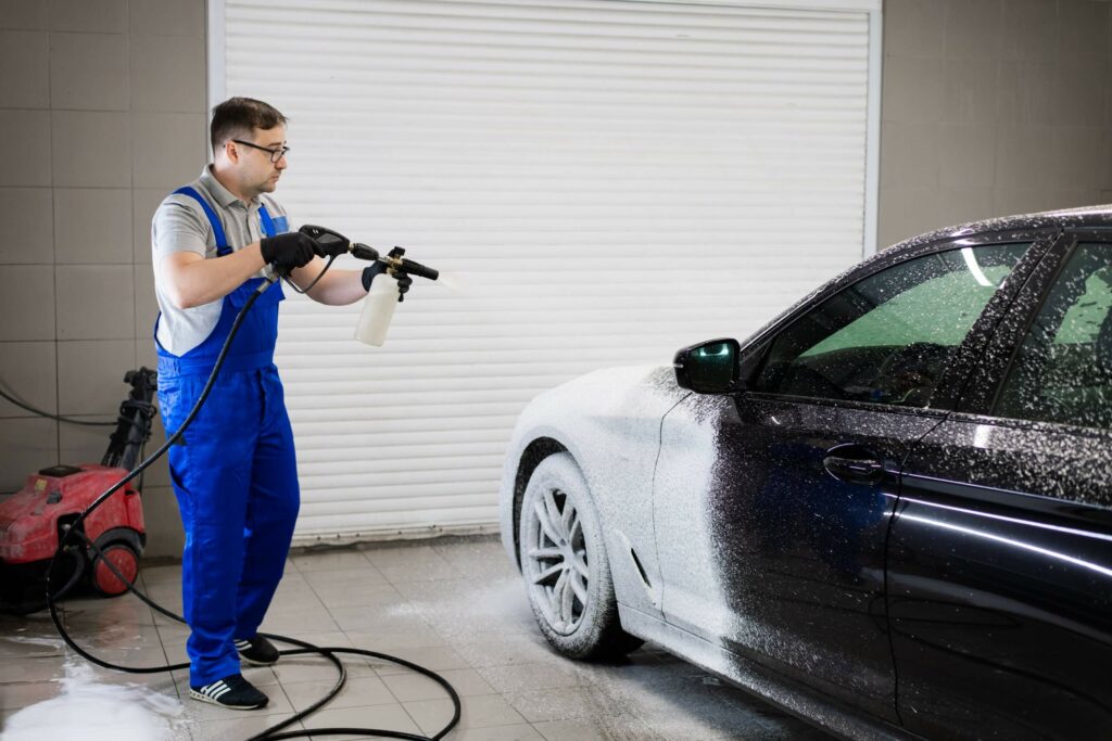 car-with-turned-on-backlights-standing-in-car-wash-GS9YBRJ-1-scaled