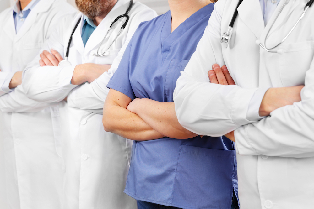 10 Questions To Ask Before Buying Staff Uniforms 3 doctors-and-nurses-in-healthcare-team-with-arms-cr-2021-08-26-16-28-56-utc