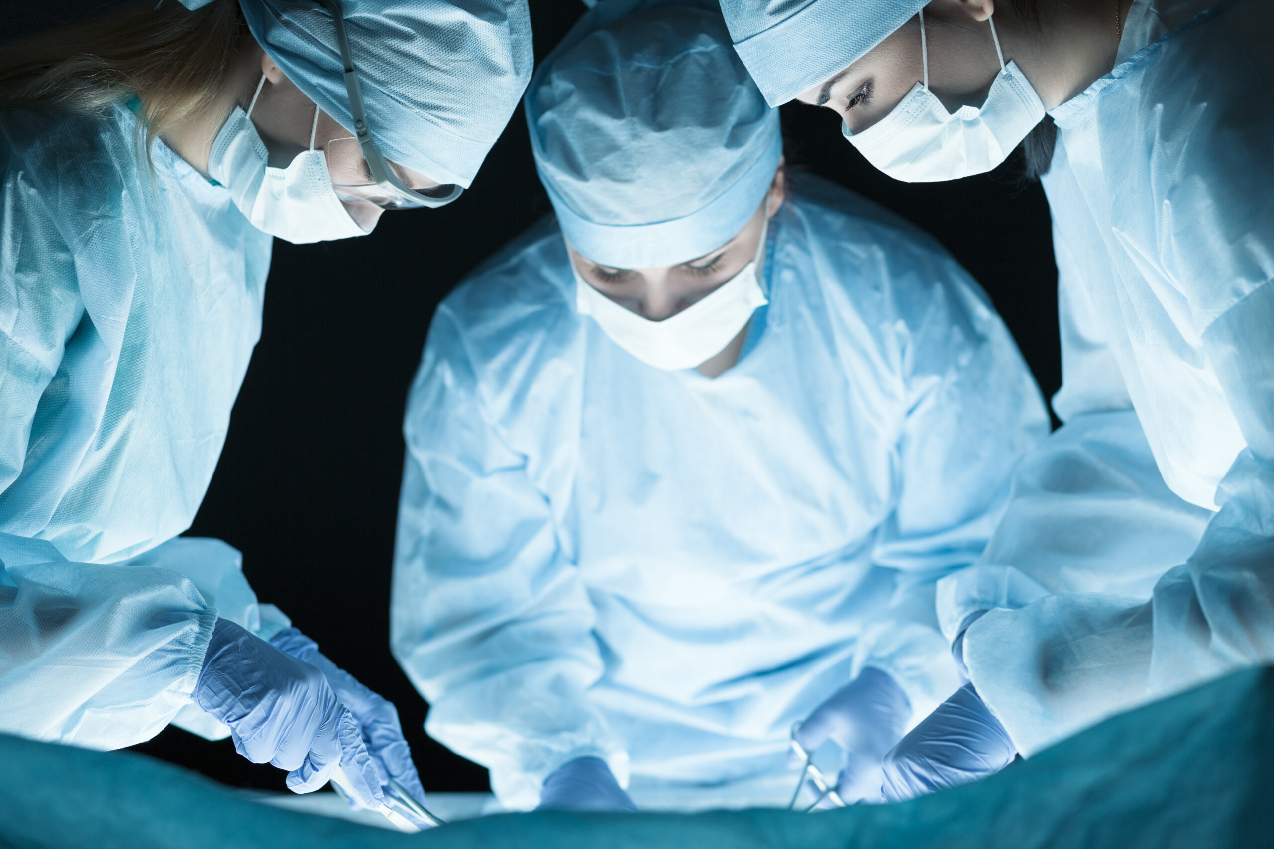How Often Should You Replace Your Scrubs? 2 Medical team performing operation